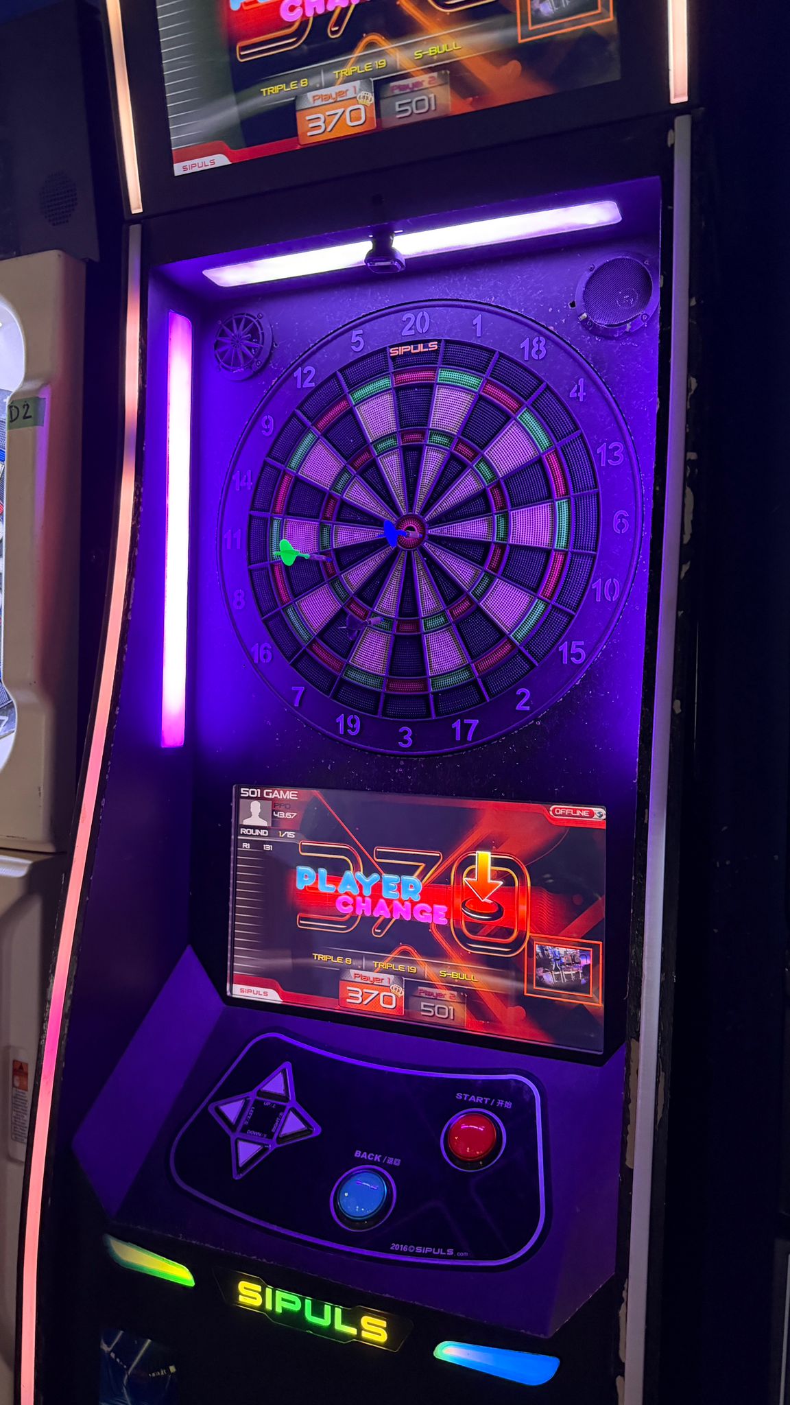 Jack and his dad playing darts at the arcade.