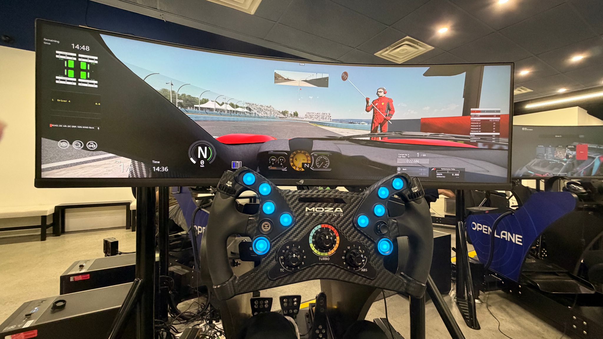 Jack in a full arcade racing rig with a bucket seat, wheel, and pedals.